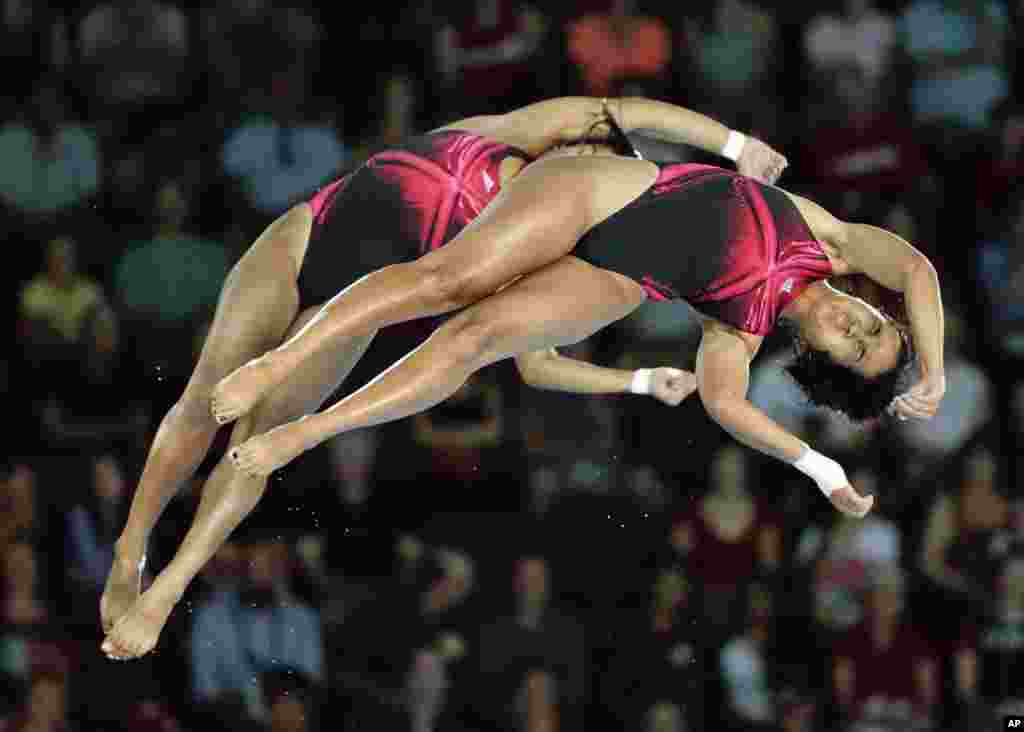 Annia Rivera and Yaima Mena of Cuba compete during the women&#39;s synchronized 10-meter platform diving event at the Pan Am Games in Toronto, Canada, July 13, 2015.