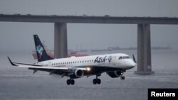 FILE - An Embraer ERJ-190AR airplane of Azul Brazilian Airlines prepares to land at Santos Dumont airport in Rio de Janeiro, Brazil, March 21, 2019.