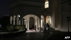 FILE - Members of Taliban negotiating team enter the venue housing the talks between U.S. and Taliban negotiators in the Qatari capital Doha, Aug. 29, 2019.