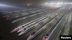 FILE - CRH380 (China Railway High-speed) Harmony bullet trains are seen at a high-speed train maintenance base in Wuhan, Hubei province. 