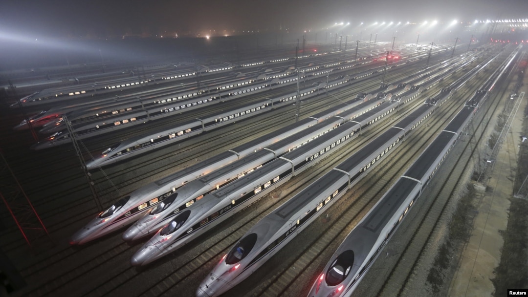 FILE - CRH380 (China Railway High-speed) Harmony bullet trains are seen at a high-speed train maintenance base in Wuhan, Hubei province, early December 25, 2012. 