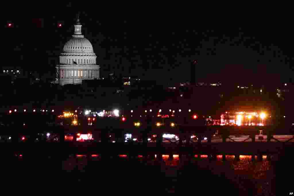 Emergency vehicles stage at Ronald Reagan Washington National Airport, Jan. 29, 2025, in Arlington. The US Capitol is seen across the Potomac River in Washington.