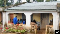 Friends in Malawi gather to listen to a segment of Reality Radio, a program with stories and interviews about girls' risks of HIV/AIDS. (Hilary Schwandt)