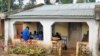 Friends in Malawi gather to listen to a segment of Reality Radio, a program with stories and interviews about girls' risks of HIV/AIDS. (Hilary Schwandt)