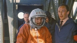 In this April 12 1961 photo, rocket engineer Oleg Ivanovsky, right, leads Yuri Gagarin, center, to the Vostok spacecraft on which he will become the first person in space