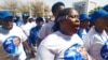 Supporters of the opposition coalition Umbrella for Democratic Change sing outside the high court in Gaborone, Botswana, during presidential nominations on Sept. 28, 2024.