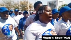 Supporters of the opposition coalition Umbrella for Democratic Change sing outside the high court in Gaborone, Botswana, during presidential nominations on Sept. 28, 2024.