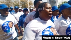 Supporters of the opposition coalition Umbrella for Democratic Change sing outside the high court in Gaborone, Botswana, during presidential nominations on Sept. 28, 2024.