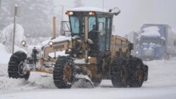 A Washington Dept. of Transportation road grader clears snow from a road near the Summit at Snoqualmie Ski Area, Dec. 9, 2021.
