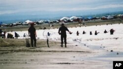 FILE - Residents line the beach along the Kenai River in Kenai, Alaska, to dipnet, July 22, 2010. 