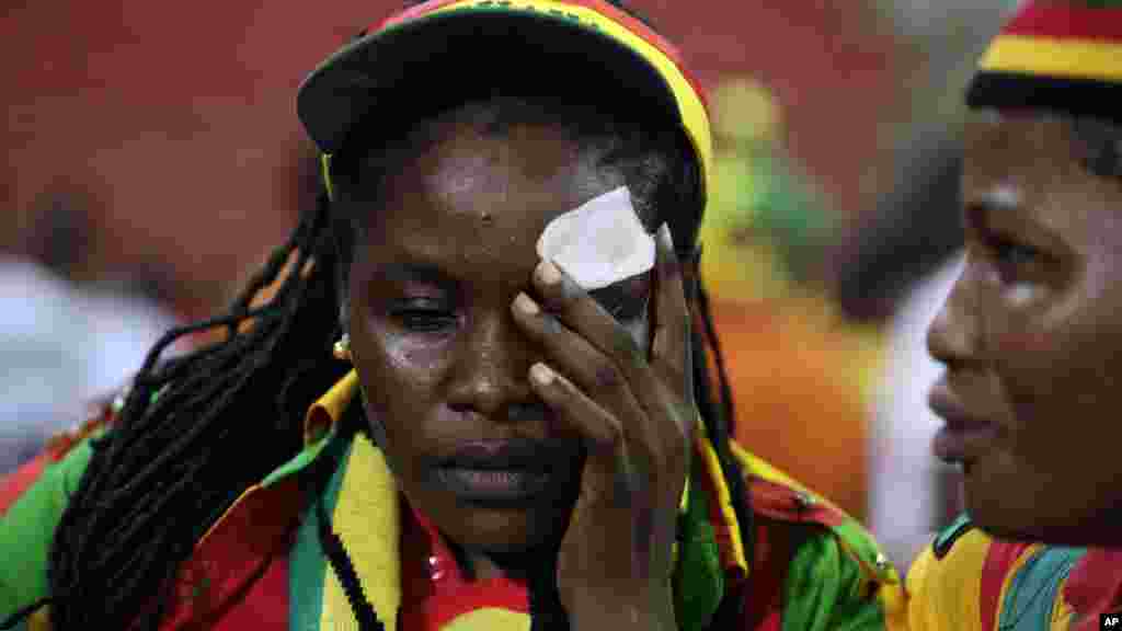 Une équato-guinéenne blessée par le jet de projectiles, pleure à la fin du match de demi-finale que son pays a perdu 3-0 contre le Ghana, le 5 février 2015, à Bata, en Guinée équatoriale.