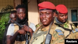 FILE PHOTO: Burkina Faso's new military leader Ibrahim Traore is escorted by soldiers in Ouagadougou