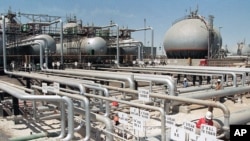 FILE - In this file photo dated 1990, Aramco refinery at Ras Tannura, Saudi Arabia. The price of oil surged Friday Jan. 3, 2020, as global investors were gripped with uncertainty over the potential repercussions and any retaliation, after the United…