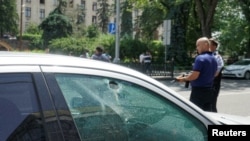 A bullet hole is seen on the window of a car parked in the street in Almaty, Kazakhstan, July 18, 2016.