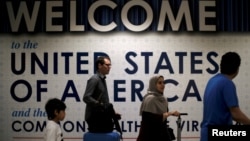 International passengers arrive at Washington Dulles International Airport after the U.S. Supreme Court granted parts of the Trump administration's emergency request to put its travel ban into effect later in the week pending further judicial review, in Dulles, Virginia, June 26, 2017.