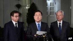 South Korean national security director Chung Eui-yong, center, speaks to reporters at the White House in Washington, March 8, 2018, as intelligence chief Suh Hoon, left and Cho Yoon-je, the South Korea ambassador to United States listen. President Donald Trump has accepted an offer of a summit from the North Korean leader and will meet with Kim Jong Un by May, a top South Korean official said.