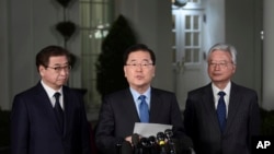 South Korean national security director Chung Eui-yong, center, speaks to reporters at the White House in Washington, March 8, 2018, as intelligence chief Suh Hoon, left and Cho Yoon-je, the South Korea ambassador to United States listen.