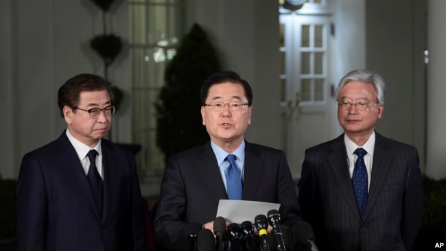 South Korean national security director Chung Eui-yong, center, speaks to reporters at the White House in Washington, March 8, 2018, as intelligence chief Suh Hoon, left and Cho Yoon-je, the South Korea ambassador to United States listen.