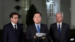 South Korean national security director Chung Eui-yong, center, speaks to reporters at the White House in Washington, March 8, 2018, as intelligence chief Suh Hoon, left and Cho Yoon-je, the South Korea ambassador to United States listen. President Donald