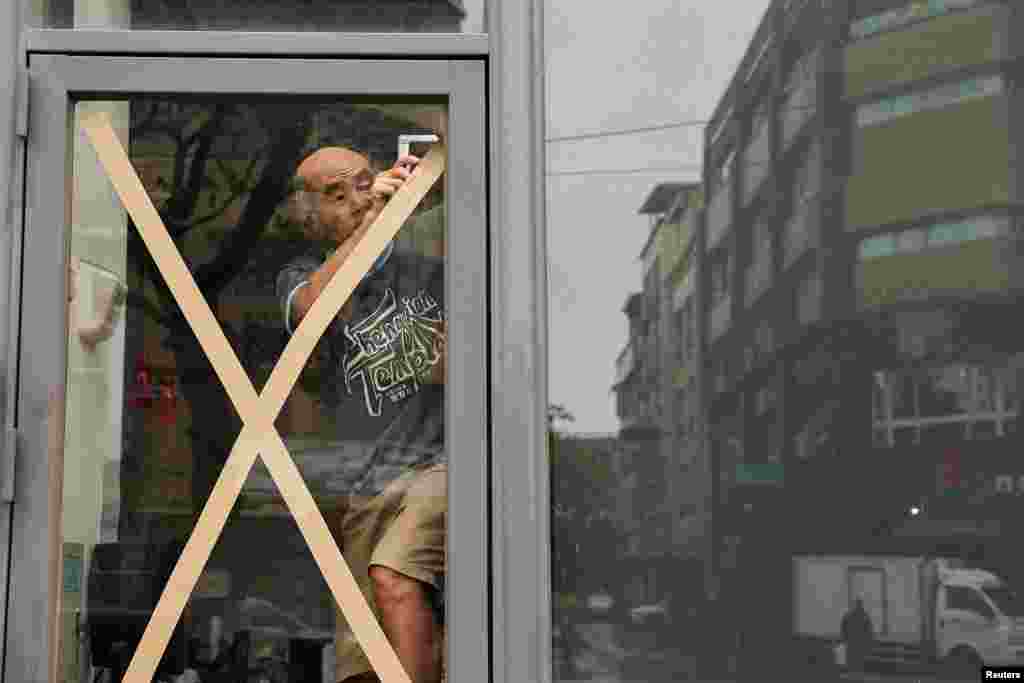 A local man prepares for Typhoon Krathon, in Kaohsiung, Taiwan.