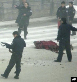 Armed police surround Tapey after he set himself ablaze in Aba, in China's southwest Sichuan province Friday, Feb. 27, 2009.