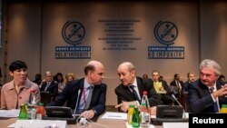 French Foreign Affairs Minister Jean-Yves Le Drian, 2nd from right, speaks with Angus Lapsley, Director for Defense at the British foreign affairs ministry, during a meeting on the International Partnership against Impunity for the Use of Chemical Weapons, in Paris, May 18, 2018. 