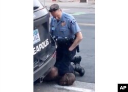 FILE - In this Monday, May 25, 2020, file frame from video provided by Darnella Frazier, a Minneapolis officer kneels on the neck of George Floyd, a handcuffed man who was pleading that he could not breathe.