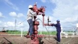 FILE - Workers are seen at an oil well at the Toma South oil field to Heglig, in Ruweng State, South Sudan, Aug. 25, 2018. 