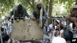 Afghan villagers look at the bodies of two children and a villager after they were allegedly killed in an airstrike by foreign troops in Kandahar, south of Kabul (file)