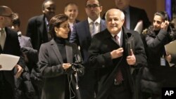 Palestinian Ambassador to the United Nations Riyad Mansour (L) and Jordanian Ambassador Dina Kawar leave a meeting of Arab states at U.N. headquarters, Dec. 29, 2014.