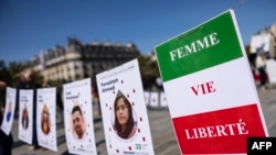 This photograph shows a slogan reads "Women, Life, Freedom" during a march on the second anniversary of a protest movement sparked by the death in custody of Mahsa Amini, in Paris, Sept. 15, 2024. 