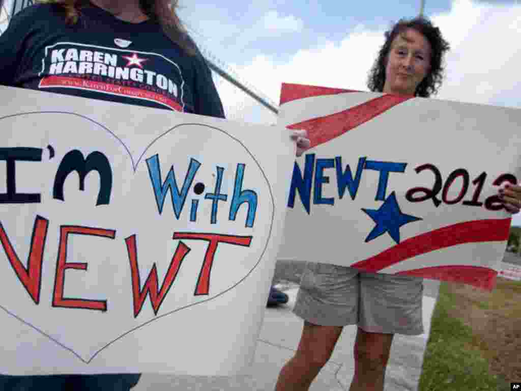 Two unidentified supporters of Republican presidential candidate Newt Gingrich stand outside a Hallande, Florida polling center on January 31, 2012 (AP)