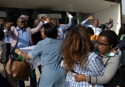 Supporters of former Ivory Coast President Laurent Gbagbo and former youth minister Charles Ble Goude celebrate their acquittal outside the International Criminal Court in The Hague, Netherlands, March 31, 2021.