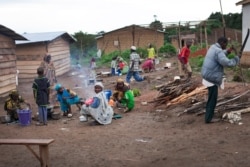 FILE - Women prepare food, April 28, 2014, in the camp for Central African refugees in Garoua Boulai in Cameroon.