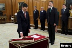 FILE - Spain's Prime Minister and Socialist party leader Pedro Sanchez is sworn in next to King Felipe during a ceremony at the Zarzuela Palace in Madrid, June 2, 2018.