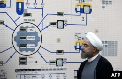 FILE - A handout picture released by the official website of the Iranian President Hassan Rouhani shows him visiting the control room of the Bushehr nuclear power plant in the Gulf port city of Bushehr, Jan. 13, 2015.
