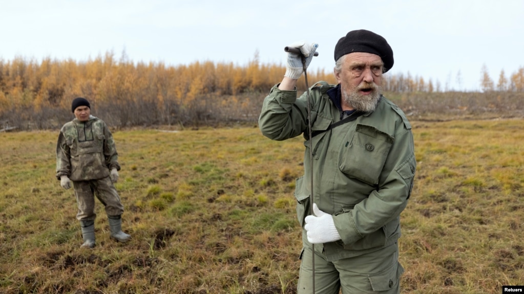 Sergey Zimov, 66, a scientist who works at Russia's Northeast Science Station, checks for permafrost at the Pleistocene Park outside the town of Chersky, Sakha (Yakutia) Republic, Russia, September 13, 2021. (REUTERS/Maxim Shemetov)