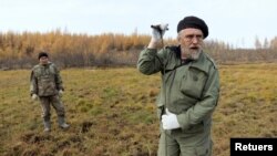 Sergey Zimov, 66, a scientist who works at Russia's Northeast Science Station, checks for permafrost at the Pleistocene Park outside the town of Chersky, Sakha (Yakutia) Republic, Russia, September 13, 2021. (REUTERS/Maxim Shemetov)