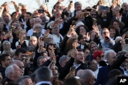 Faithful wait for the start of a mass celebrated by Pope Francis in Ajaccio "Place d'Austerlitz" during his visit in the French island of Corsica, Dec. 15, 2024.