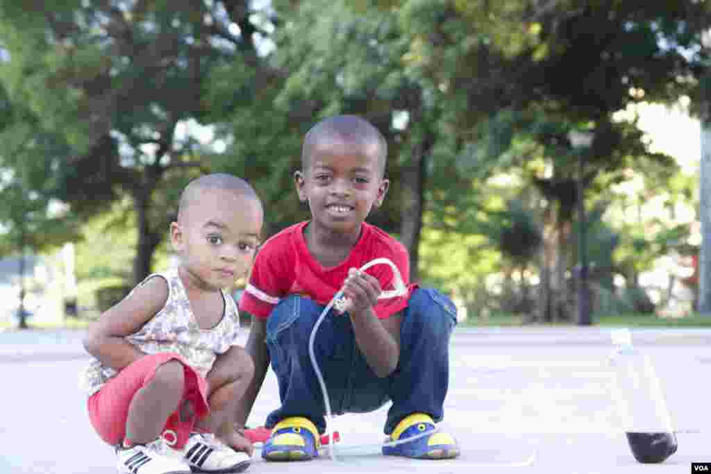 Little brothers play in a public park in Havana, Cuba, Aug. 13, 2015. (Celia Mendoza/ VOA) 