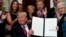 FILE - President Donald Trump smiles after signing an executive order to make it easier for Americans to buy bare-bone health insurance plans and circumvent Obamacare rules, at the White House in Washington, Oct. 12, 2017.