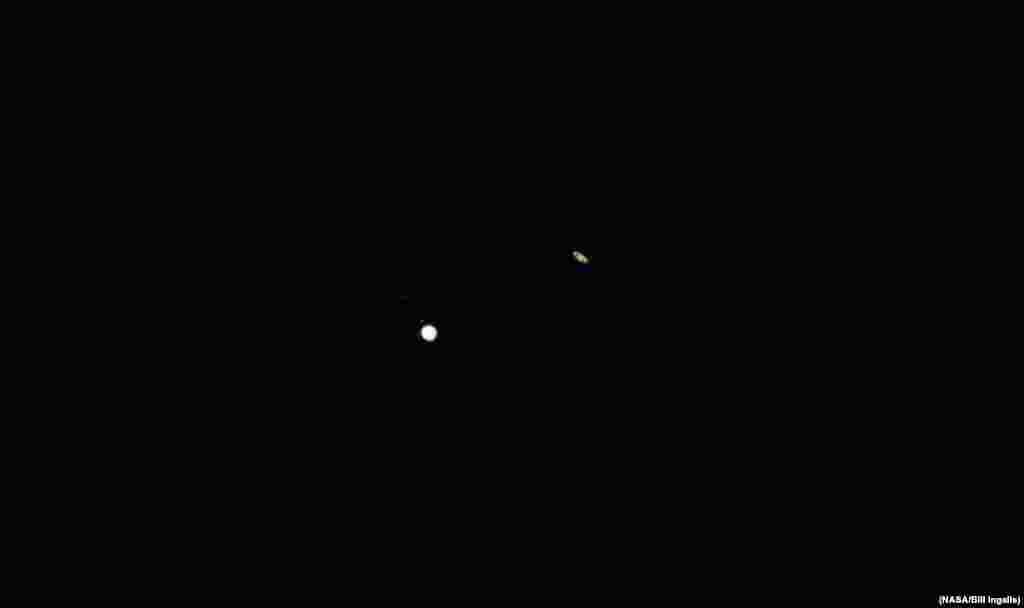 Jupiter, left, and Saturn, right, are seen during the “great conjunction” where the two planets appear a tenth of a degree apart from one another, Dec. 21, 2020, near Chapel Hill, North Carolina. (Credit: NASA)