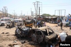 FILE - A general view shows the scene of a car bomb explosion at a checkpoint in Mogadishu, Somalia, Dec. 28, 2019.