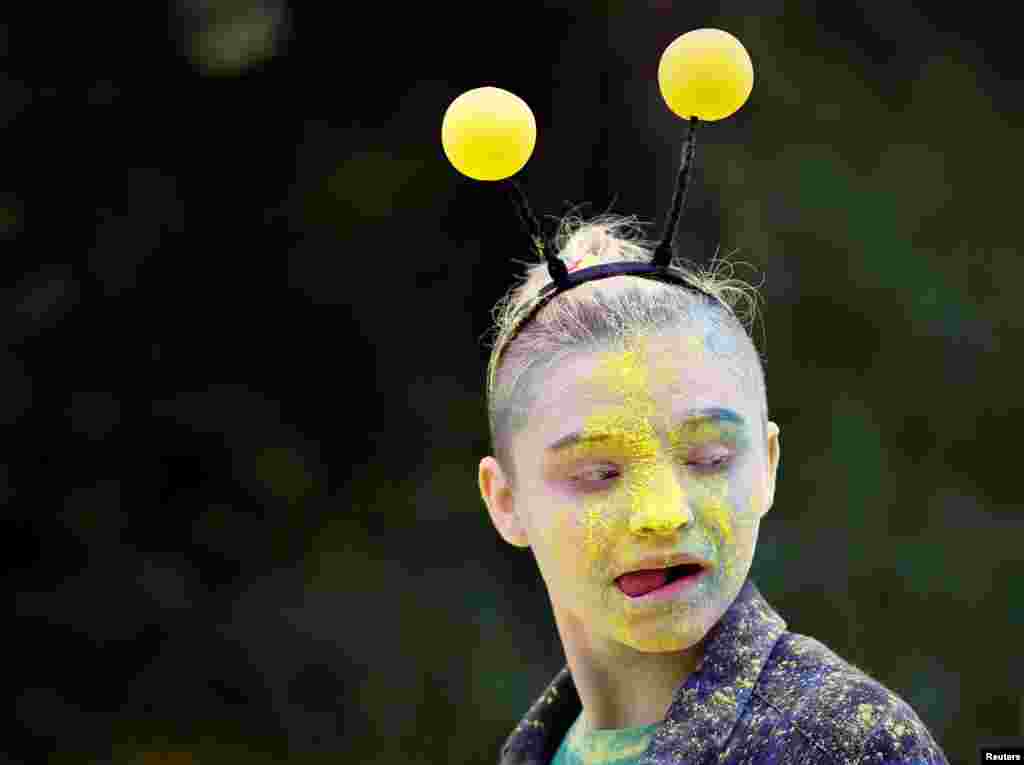 A volunteer reacts during the YARKOcross color run race in Almaty, Kazakhstan.