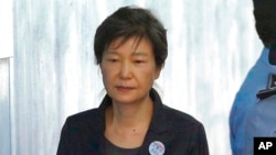 FILE - Former South Korean President Park Geun-hye arrives to attend a hearing on the extension of her detention at the Seoul Central District Court in Seoul, South Korea on Oct. 10, 2017.