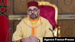 A picture released by the Moroccan Royal Palace shows Morocco's King Mohammed VI addressing speech, transmitted via a screen to the parliament, from the Royal Palace in Fez, on Oct. 8, 2021.