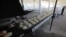 FILE - A man sweeps the floor near bread at a bakery in Azaz, Syria, Jan. 26, 2020.