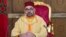 A picture released by the Moroccan Royal Palace shows Morocco's King Mohammed VI addressing speech, transmitted via a screen to the parliament, from the Royal Palace in Fez, on Oct. 8, 2021.