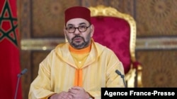 A picture released by the Moroccan Royal Palace shows Morocco's King Mohammed VI addressing speech, transmitted via a screen to the parliament, from the Royal Palace in Fez, on Oct. 8, 2021.