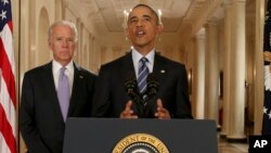 President Barack Obama, standing with Vice President Joe Biden, delivers remarks in the East Room of the White House in Washington, Tuesday, July 14, 2015, after an Iran nuclear deal is reached. (AP Photo/Andrew Harnik, Pool)